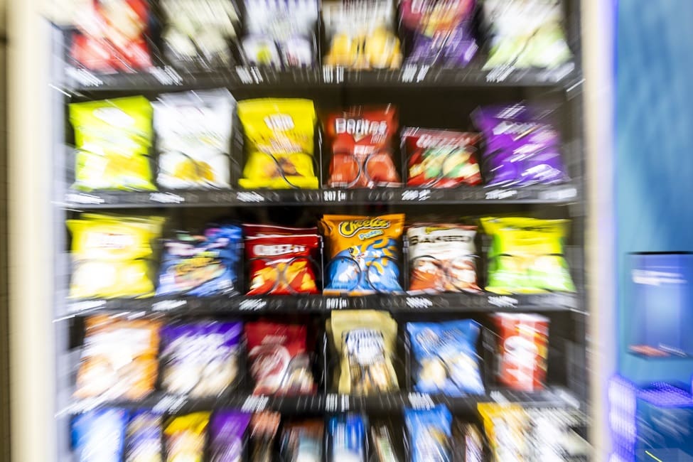 Blurry vending machine filled with snack bags.