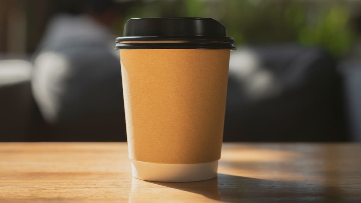 Brown paper coffee cup on wooden table