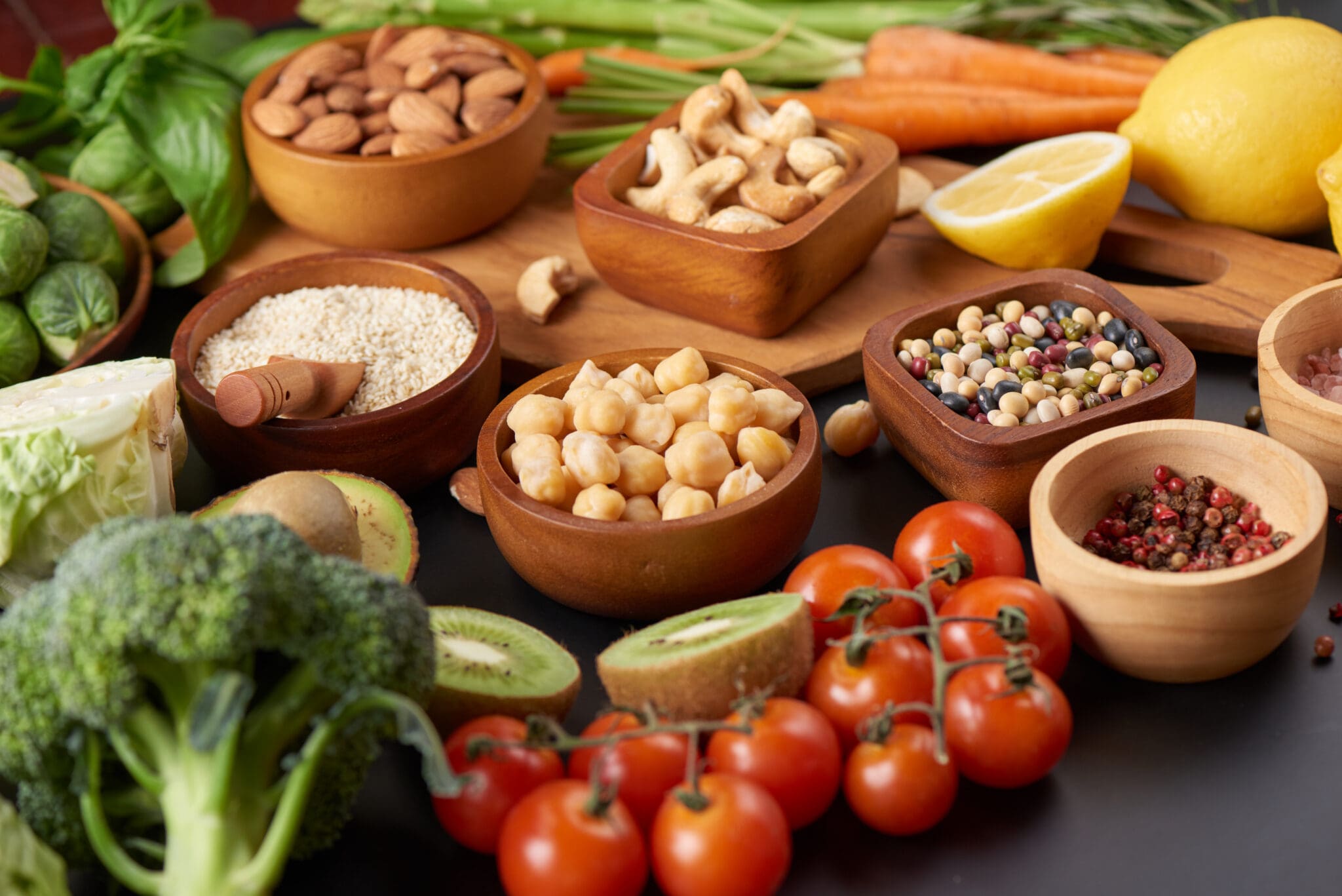 Different vegetables, seeds and fruits on table. Healthy diet.
vegetarian, vegan food cooking ingredients. Flat-lay of vegetables, fruit, beans, cereals, kitchen utencil, dried flowers, top view.