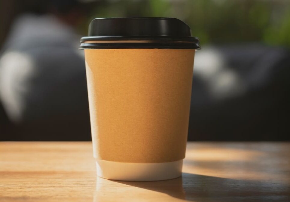 Brown paper coffee cup on wooden table