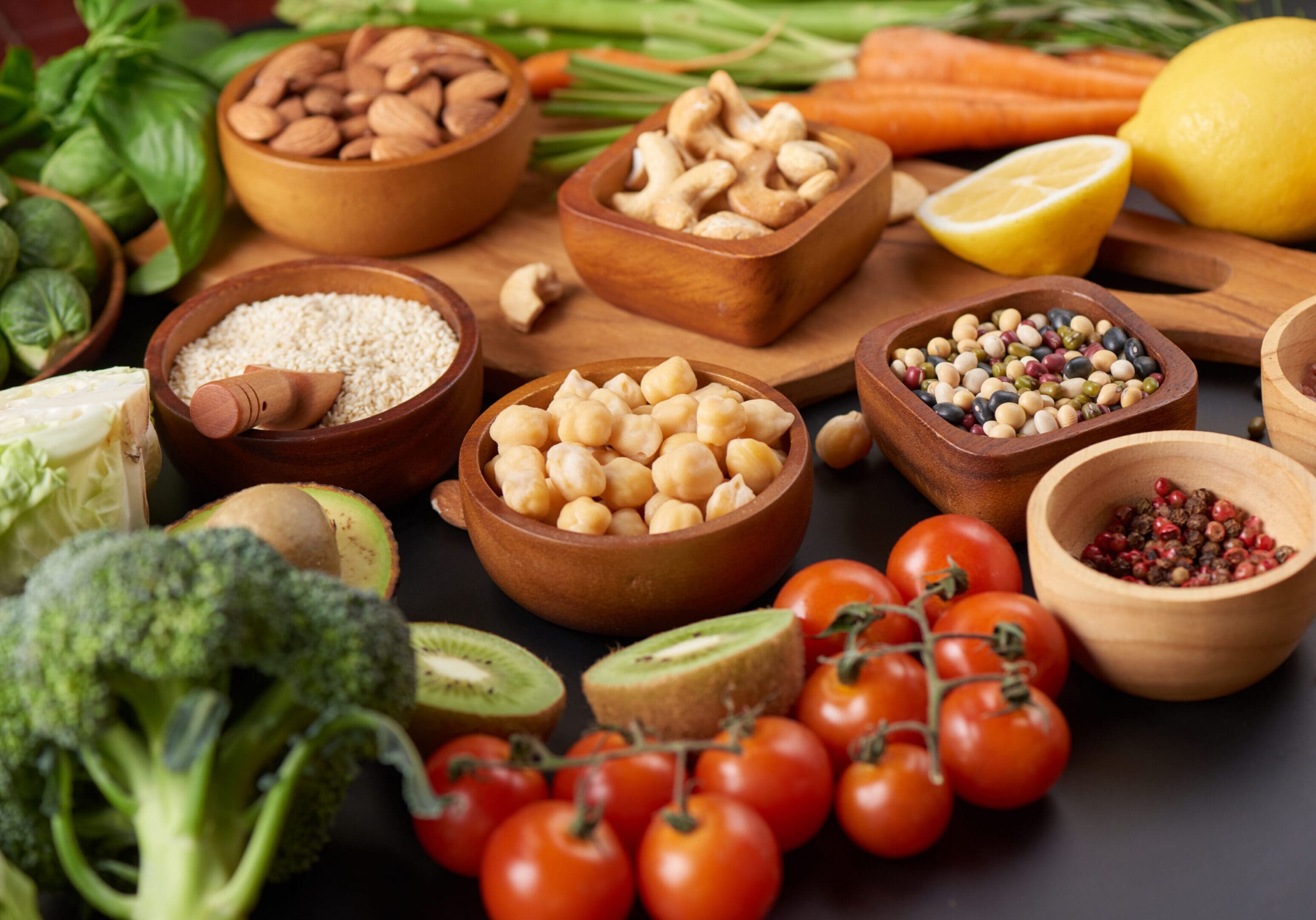Different vegetables, seeds and fruits on table. Healthy diet.
vegetarian, vegan food cooking ingredients. Flat-lay of vegetables, fruit, beans, cereals, kitchen utencil, dried flowers, top view.